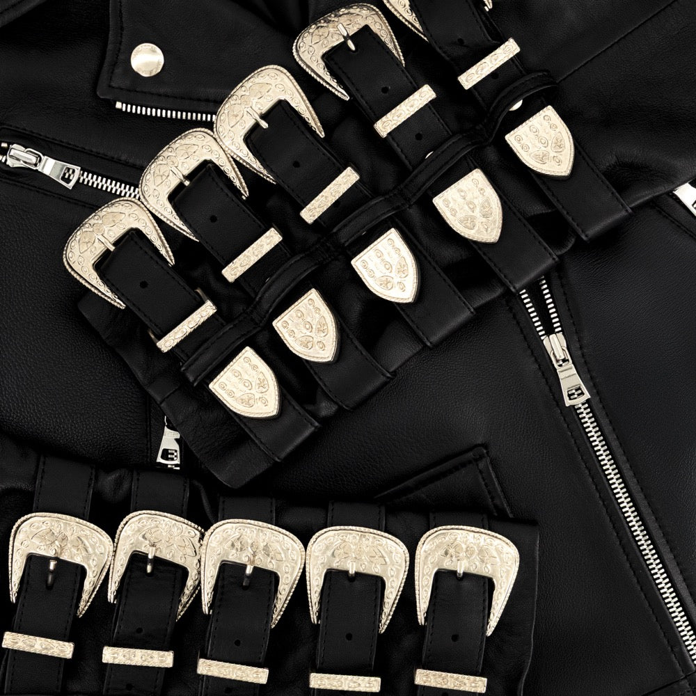 Black leather jacket with gold buckles on a black background